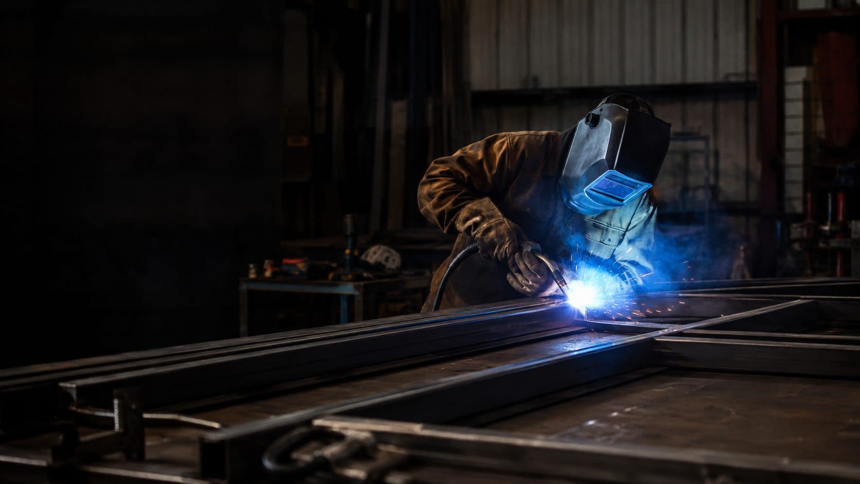 A RedHawk Fab welder laying a bead on a steel frame